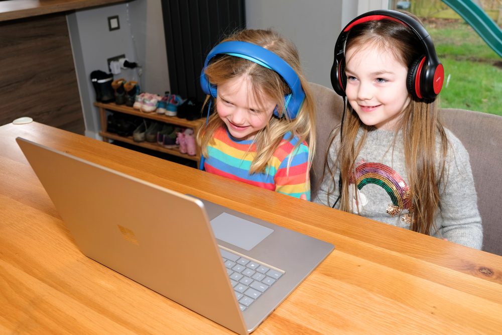 Two children having a virtual education session on a laptop