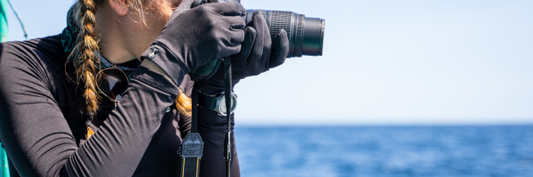 person taking a picture from a boat