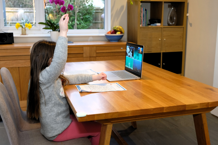 Child doing a homeschool lesson on a laptop